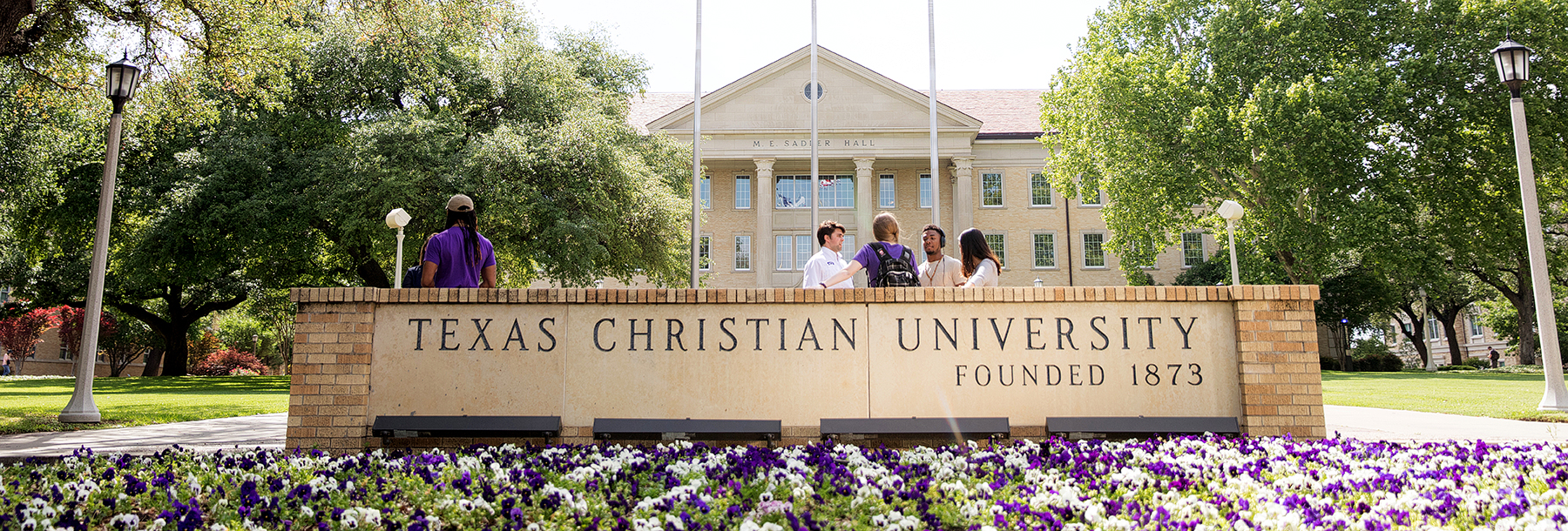 Section Image: students at TCU sign in front of Sadler Hall 