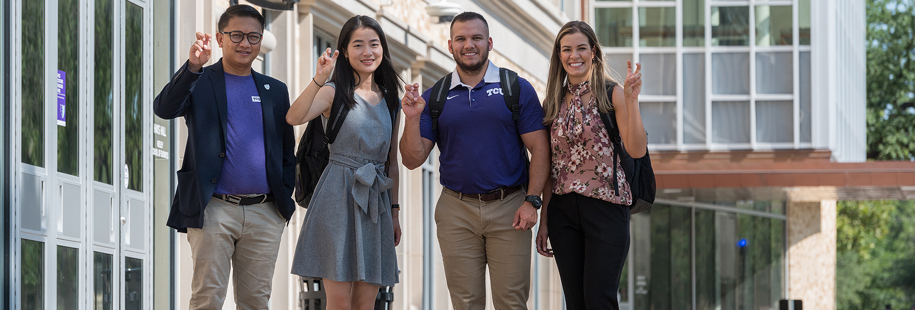 Section Image: Four MBA students with Frogs Up in front of Hays Hall 
