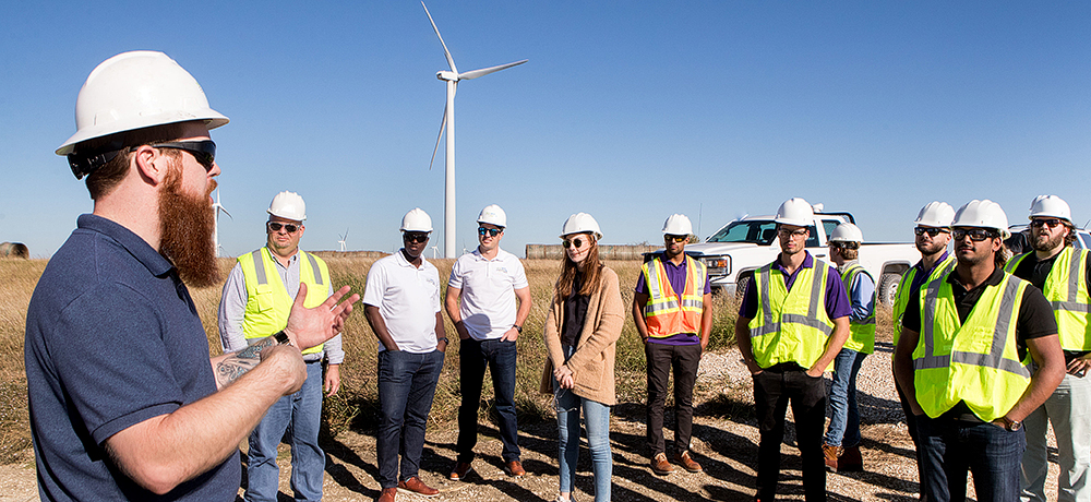 Group in hardhats with windmills