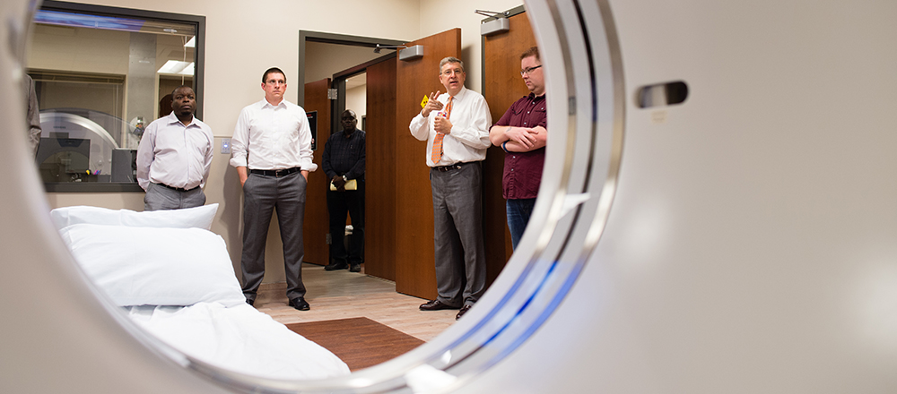 Section Image: Four men with CAT scanner 