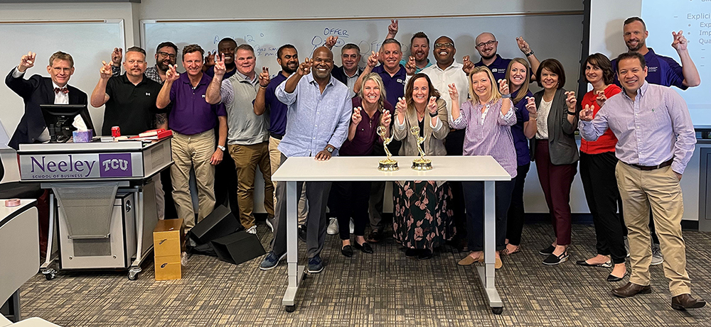 Section Image: Gregg Lehman and the EMBA class celebrate the win of fellow Horned Frog Newy Scruggs. 
