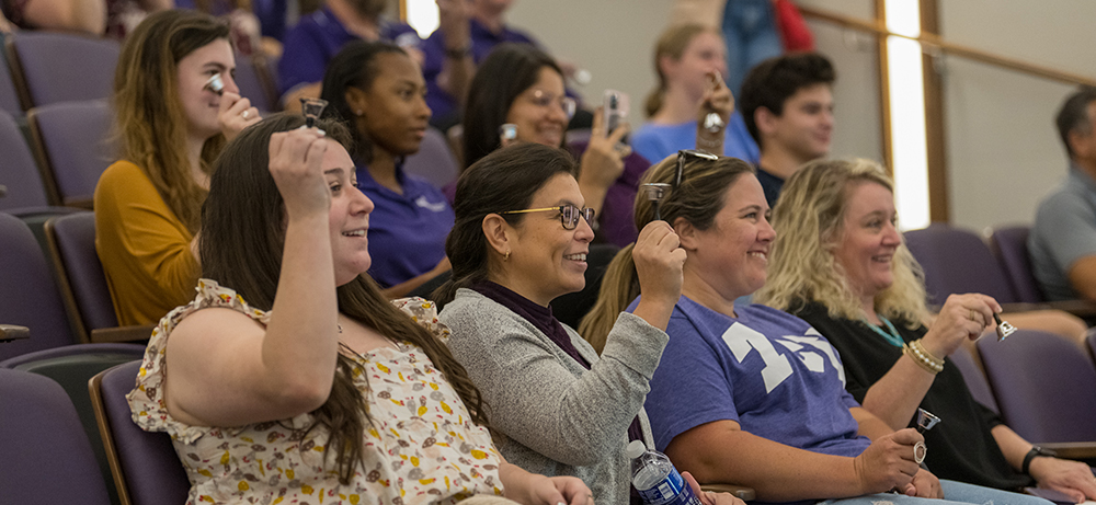 Faculty and staff assembled in the Shaddock Auditorium in Fort Worth to watch a live stream of the bell ringing with small bells of their own.