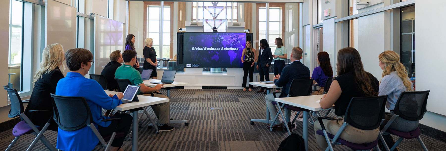 Section Image: Group of students presenting in the Rees Jones Incubator Lab 