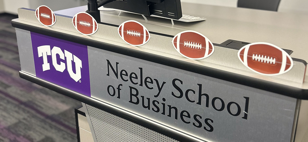 TCU Neeley desk with footballs