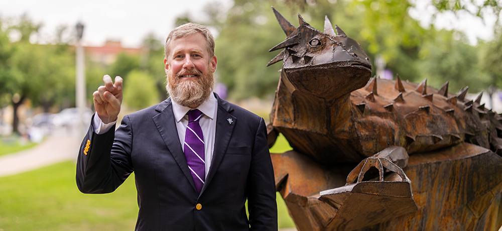 Dean Crossland with the iron horned frog statue