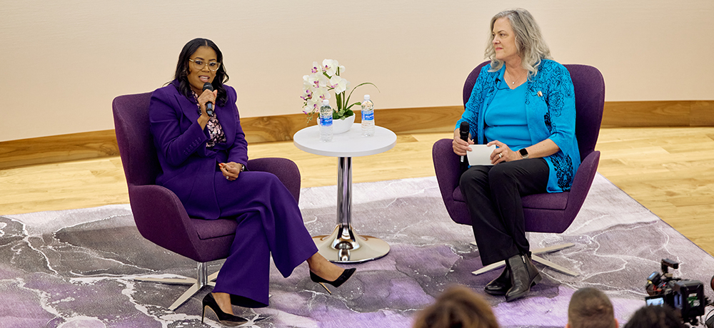 Thasunda Brown Duckett and Yohna Chambers-Hastings on stage in the Shaddock Auditorium