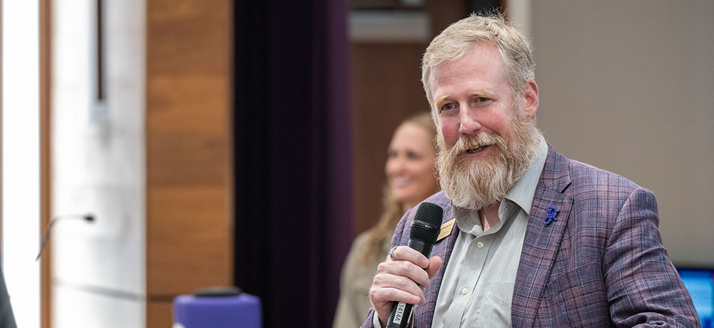 Craig Crossland on stage in Shaddock Auditorium