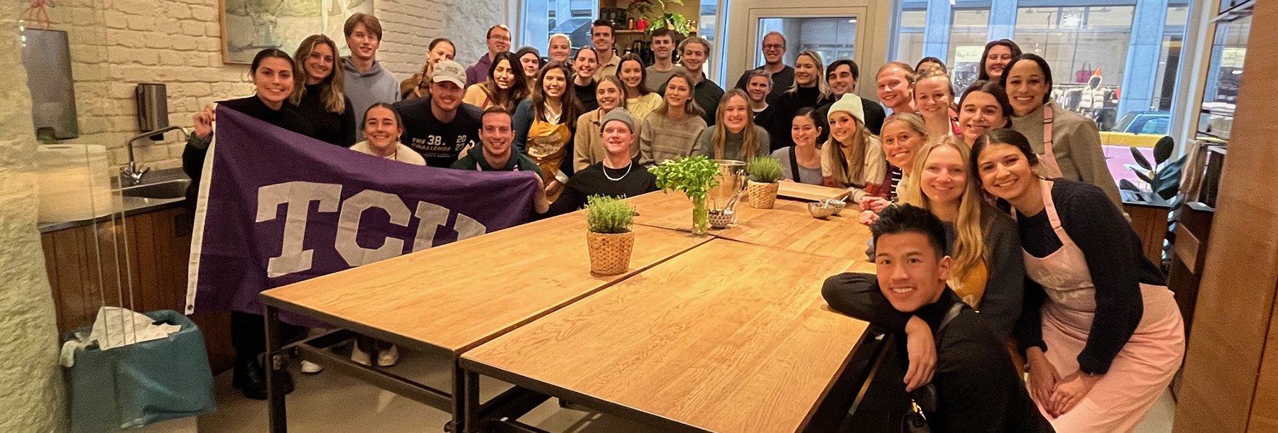 Section Image: Master of Accounting study abroad students around a table 