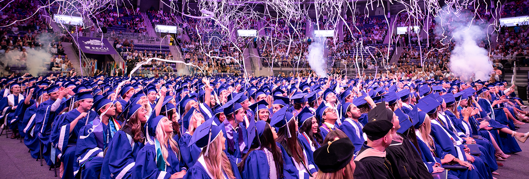 Section Image: Graduates watching as confetti rains down on them 