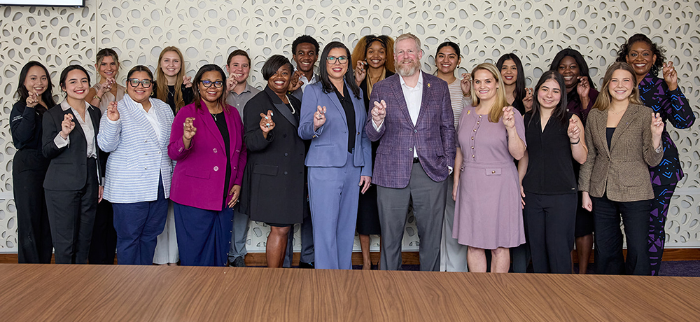 Kalisha Holland with TCU students and faculty and staff in the Neeley Boardroom