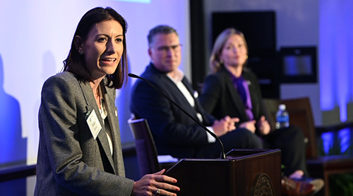 Section Image: Jennifer Engel and the three men from Four Sevens Oil on the stage at the 2024 Global Energy Symposium 