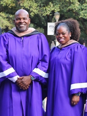 Newy Scruggs and Monica Martin in purple graduation robes