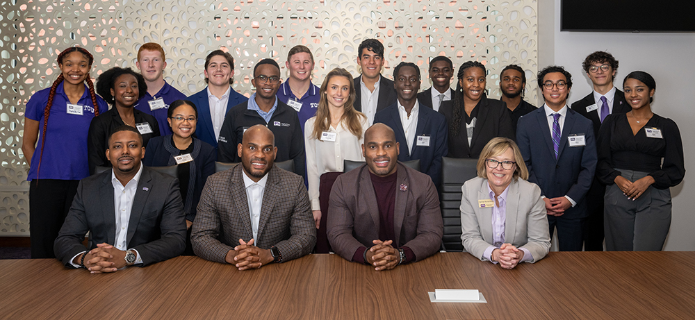 TESS speakers with group of students and Dean Richardson in the Neeley Boardroom